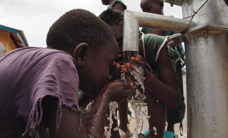 MAPS- for our survival - close-up-of-two-children-drinking-water-on-water-pump